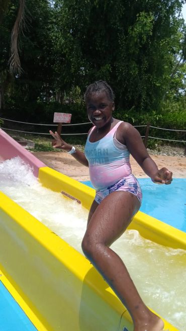 Girls playing on slides at a community event