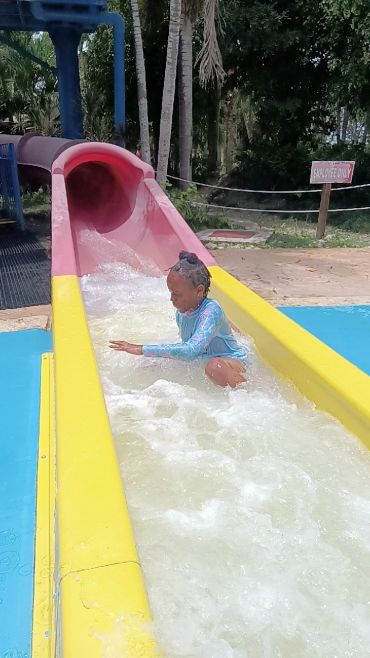 Children enjoying slides at a Wawa Aba Wellness event