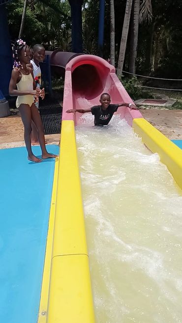 Children playing on slides at a Wawa Aba Wellness community event